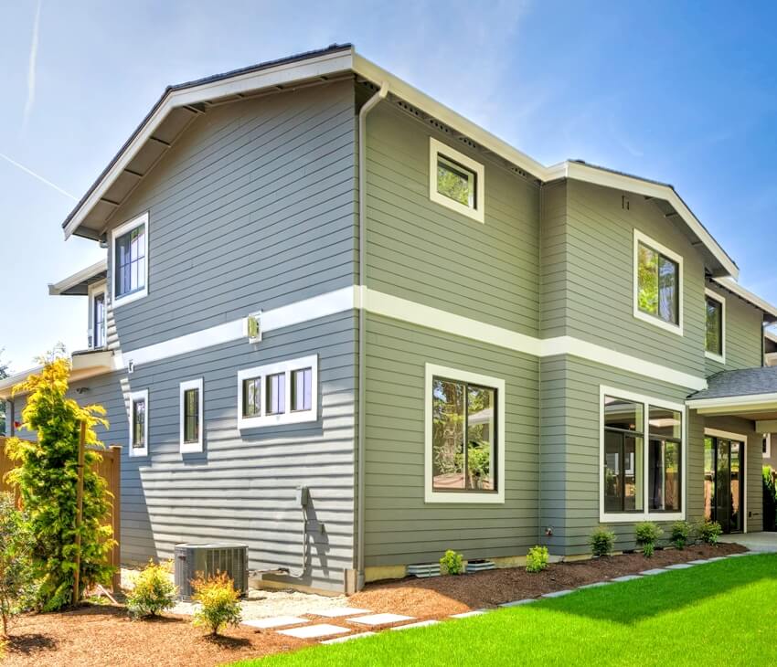 A large modern grey house with metalized tint