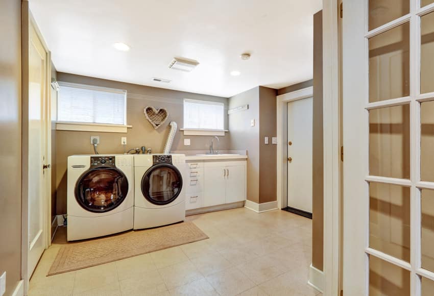 Laundry room with ceramic tile flooring, washing machine, dryer, windows, and ceiling lights
