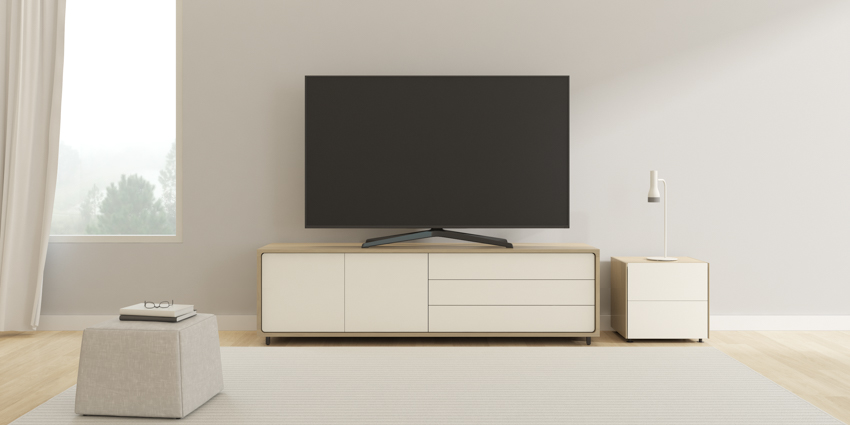 Living room area with simple TV stand, small storage space, television, and window
