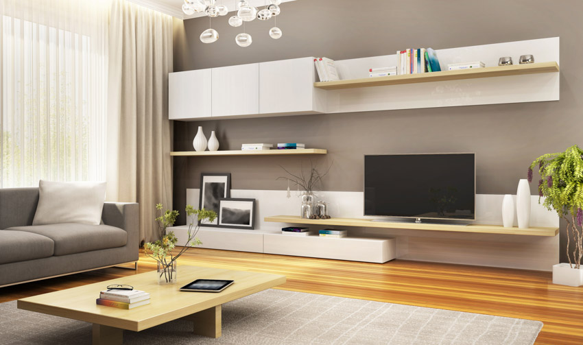 Living room with floating TV stand, coffee table, television, couch, and window curtains