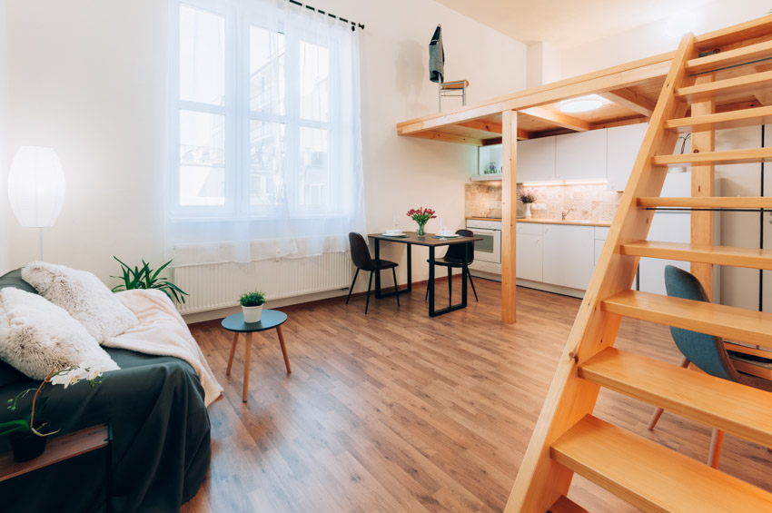 Room with loft, stairs, table, chairs, sofa ,couch, and pecan wood flooring