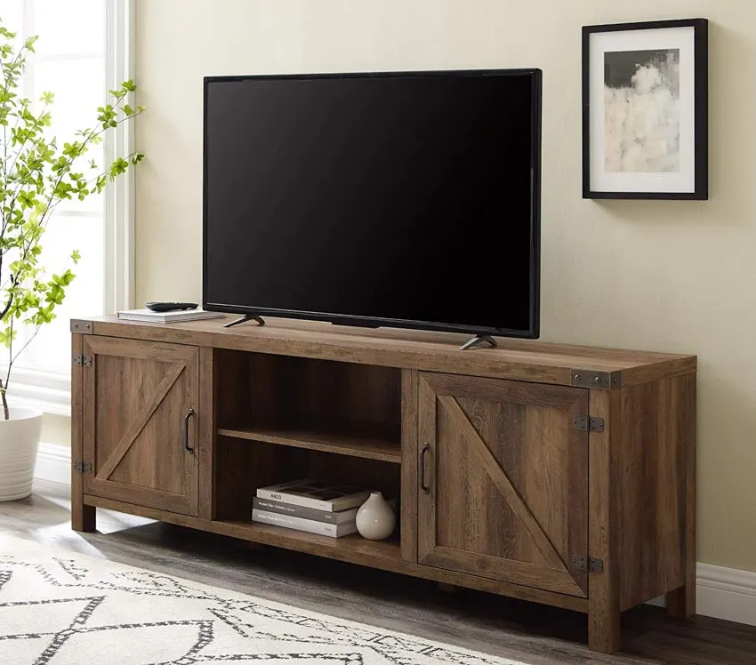 Television stand made of oakwood, light yellow walls and wall art