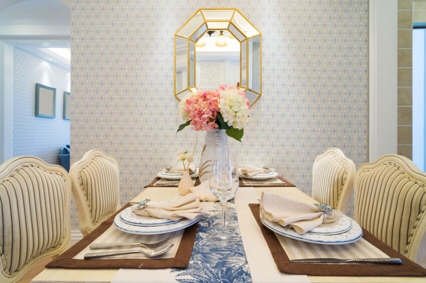 A luxury dining room with table set and elegant wall paper decoration with mirror