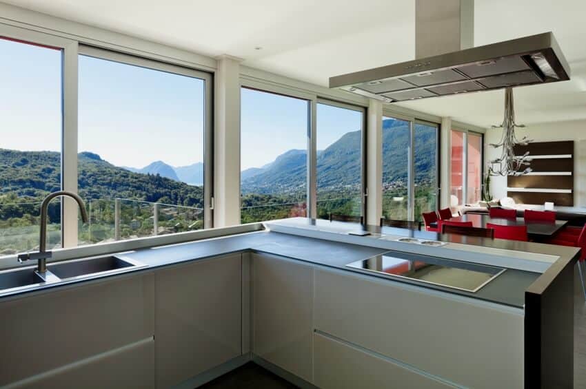 Modern style kitchen with matte countertops, dining set and a beautiful view of greenland