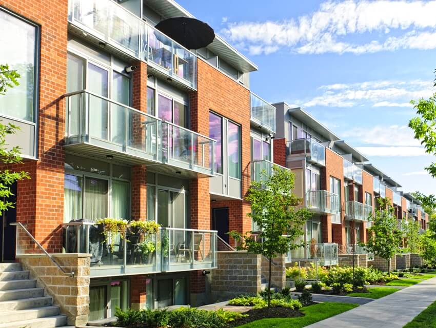 Modern town houses of brick and glass balconies on urban street