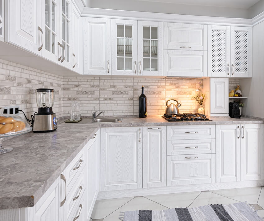 Modern white wooden kitchen interior with partial overlay shaker cabinets