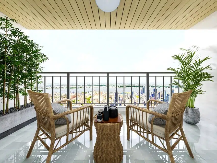 Amazing view in open balcony with steel railings, leisure tables chairs, and green plants