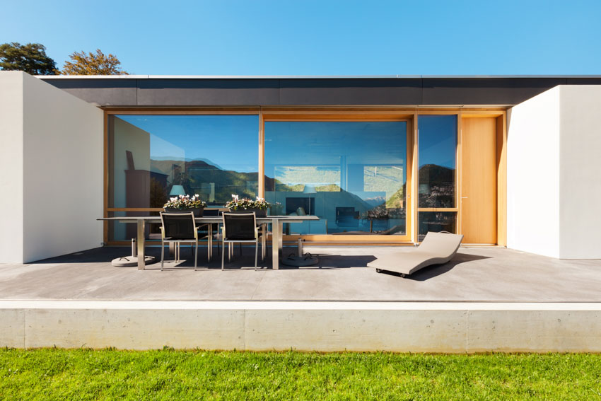 Modern concrete backyard space with wood wall accents