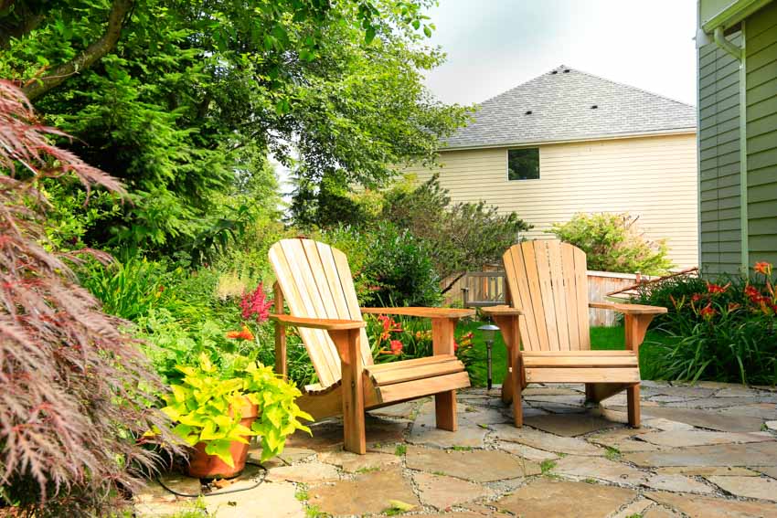 Outdoor area with garden stone flooring, and a pair of Muskoka chairs