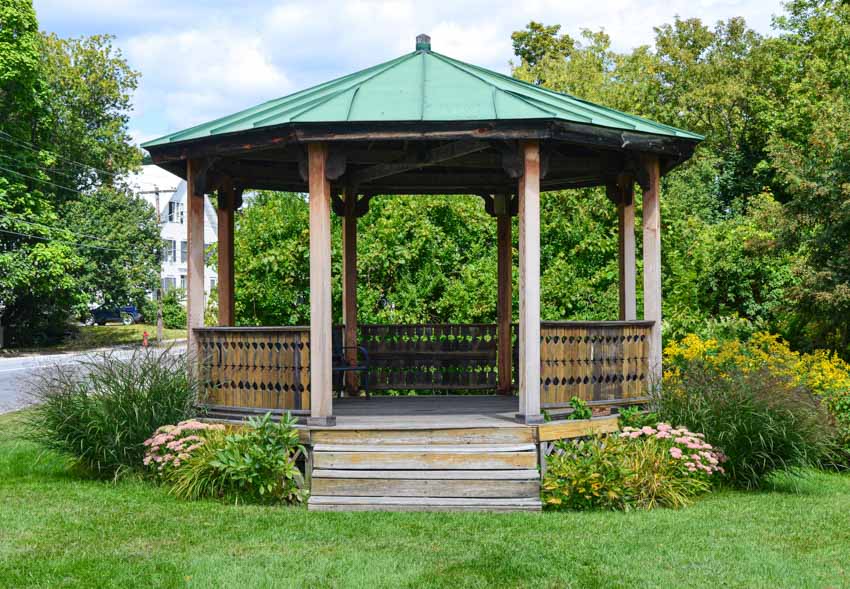 Outdoor area with gazebo, green roof, and wood railings
