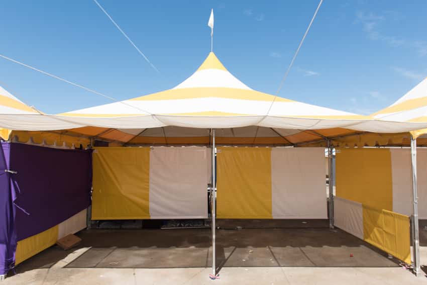 Outdoor area with white yellow and purple canopy tent for parties, and events
