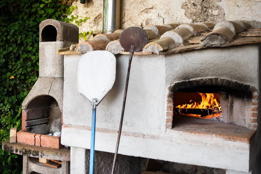 Cement fireplace with burning wood inside