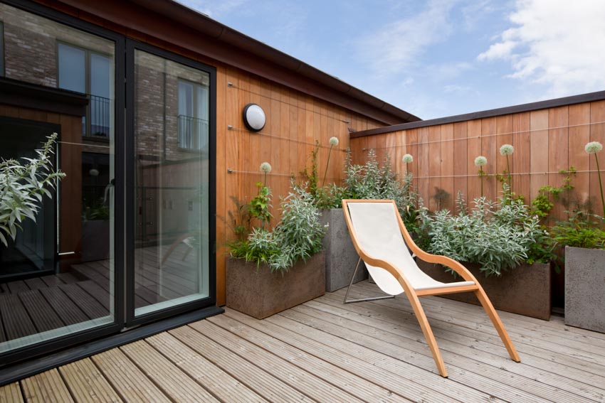 a small balcony with a lounge chair