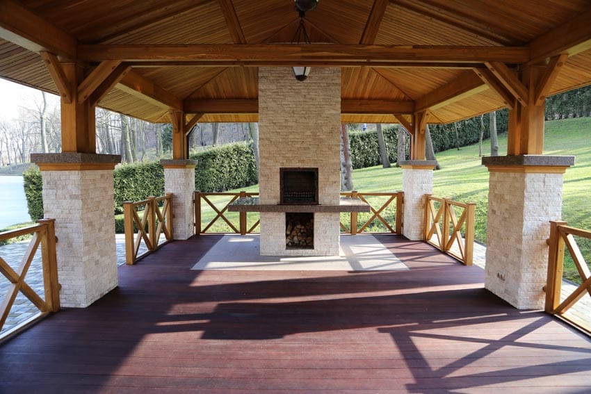 Pavilion with fireplace, wood flooring and pillars with stone cladding