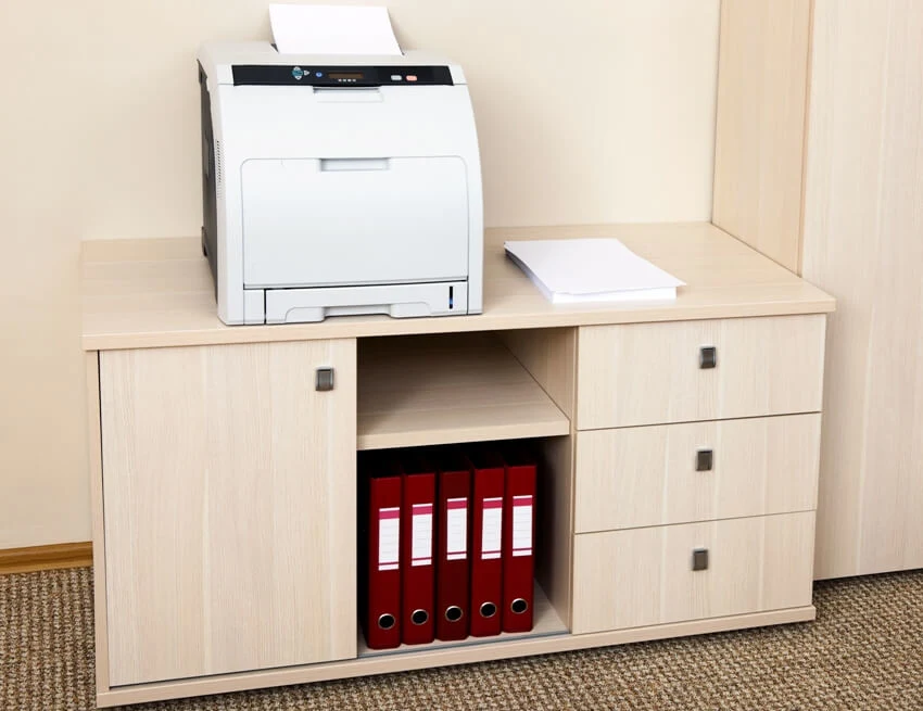 A printer on filing cabinet in a modern office