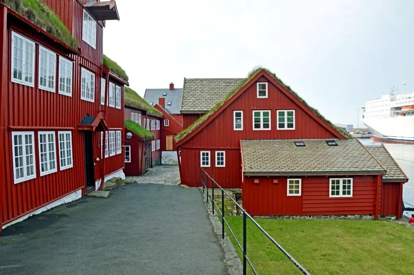 Red houses with dark red facades and planted roofs