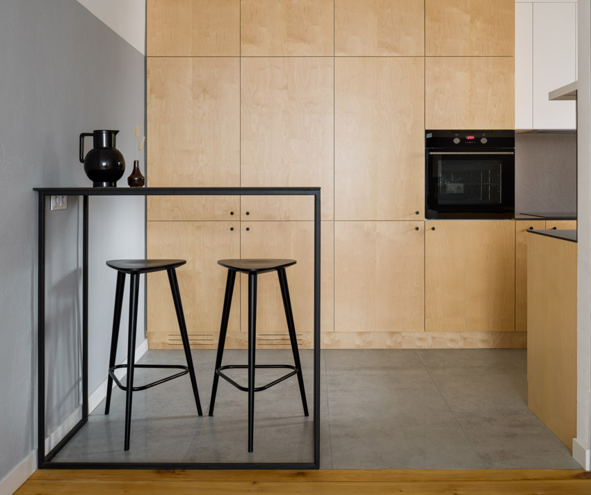 Simple kitchen with minimalist three legged stools