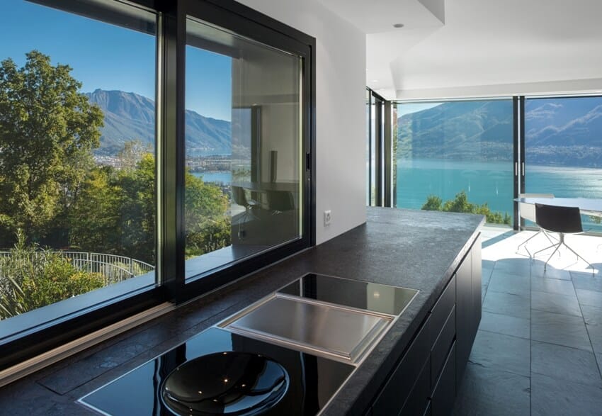 Stunning kitchen interior with insulation film window tints and a beautiful view of ocean and mountains