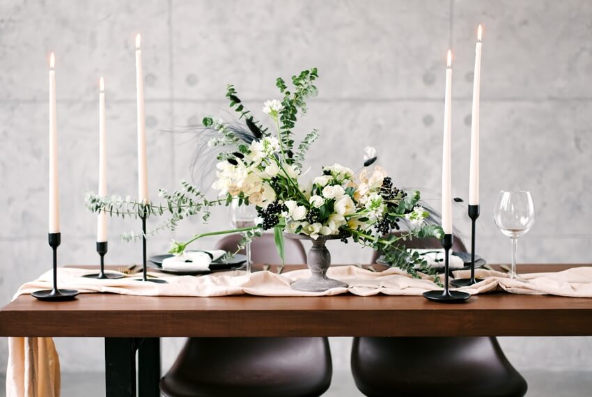 Beautiful table setting with beautiful flowers in a vase and candles on the table