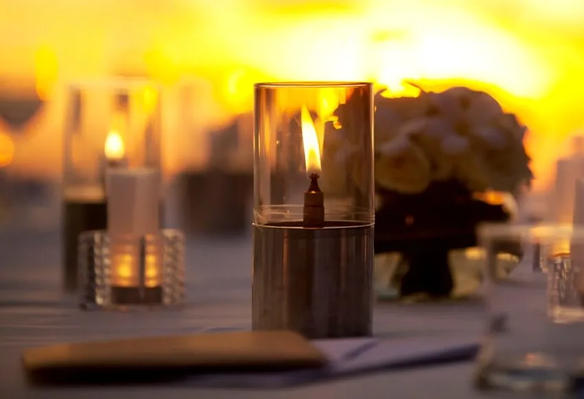 Beautiful table setting with hurricane candle holders