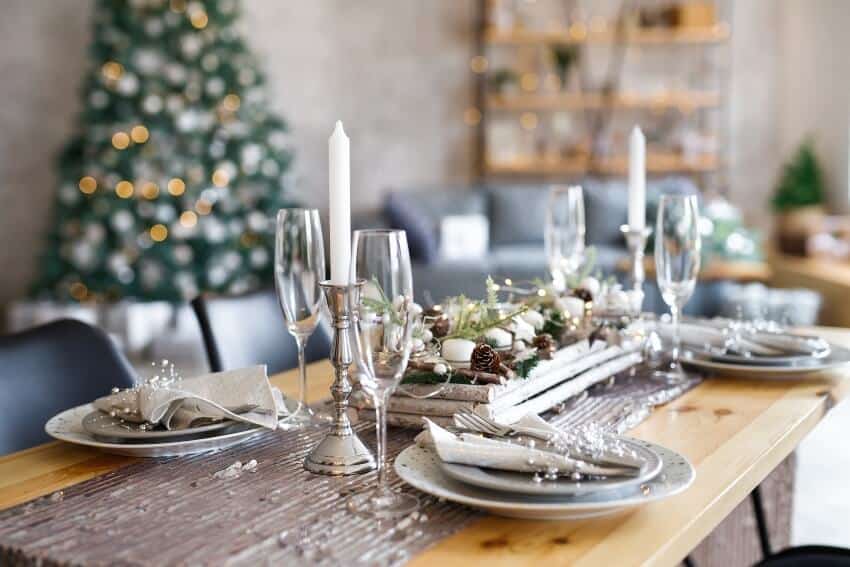 Table with silverware set and holiday decorations