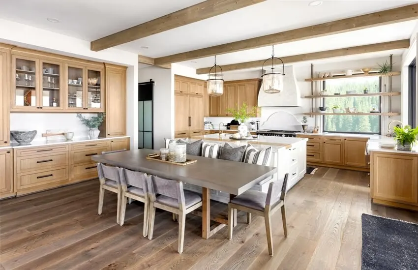 Traditional farmhouse style kitchen in new luxury home with hardwood floors, wood beams, large island and quartz counters