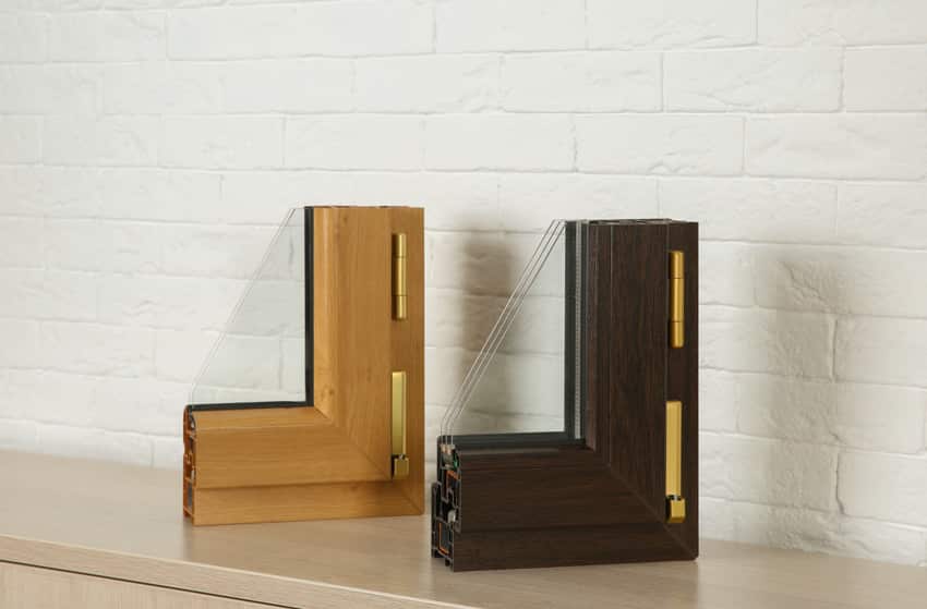 Two cutout wood frames containing glass for windows