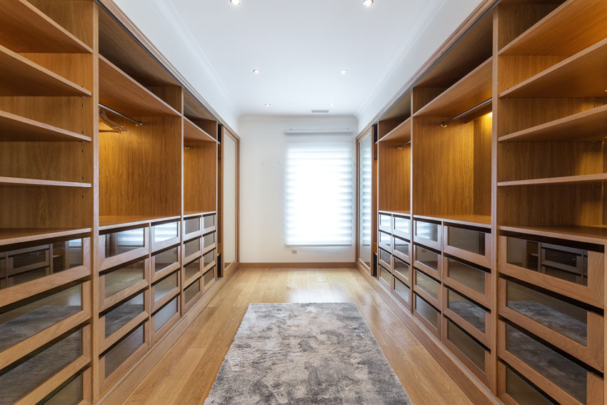 Walk-in cedar closet with wood floor, rug, and window