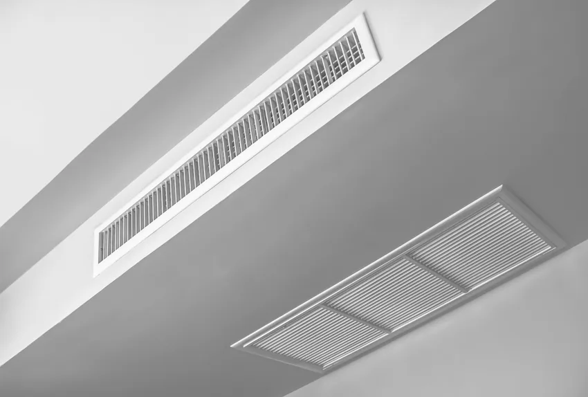 White ceiling with air vent connected to duct