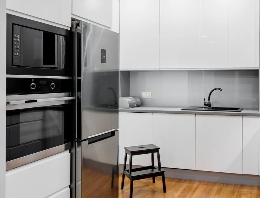 White high gloss kitchen with microwave and oven