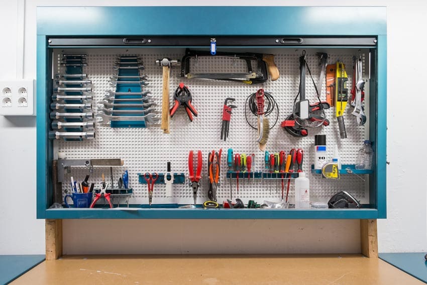 Backsplash made of pegboard filled with tools