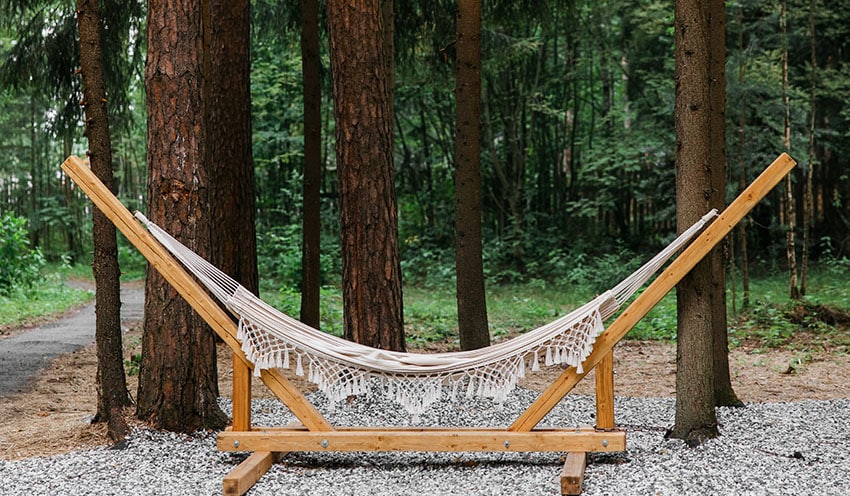 Hammock with wooden stand in backyard