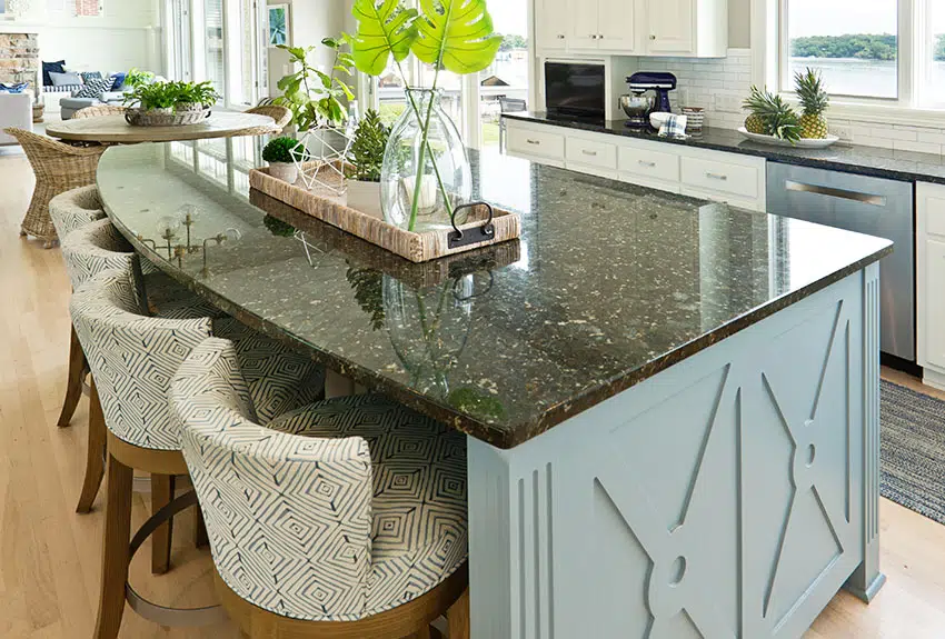 Kitchen island with granite countertop indoor plant upholstered stool chairs