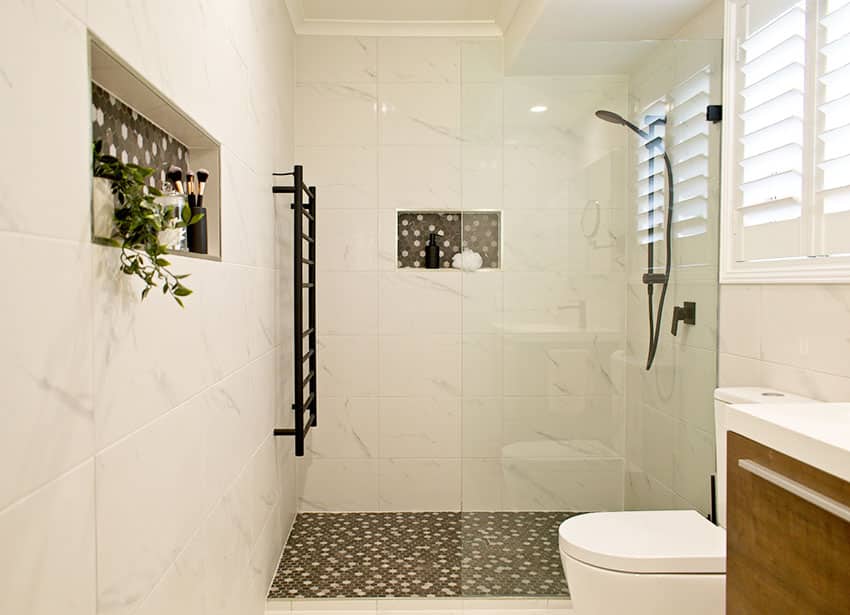 Small bathroom with doorless shower stall towel hanger