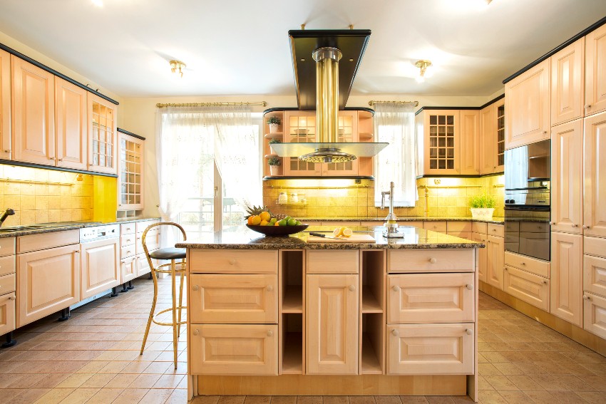 A beautiful traditional kitchen interior with island and white oak cabinets