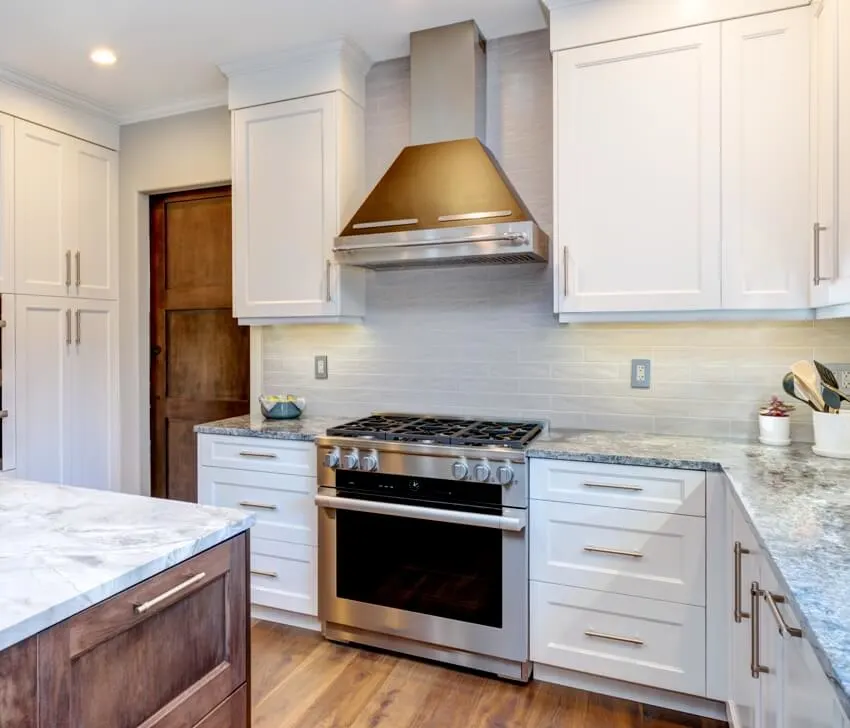 Amazing kitchen with custom white shaker cabinets and gas stovetop