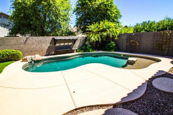 Gunite Pool Pros And Cons Colors Finishes   Backyard Area With Gunite Pool And Brick Fence Is 561x374 