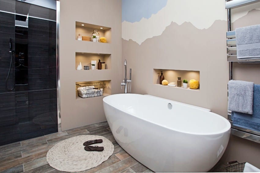 Bathroom interior with white bathtub, accent wall paint and bathroom essentials