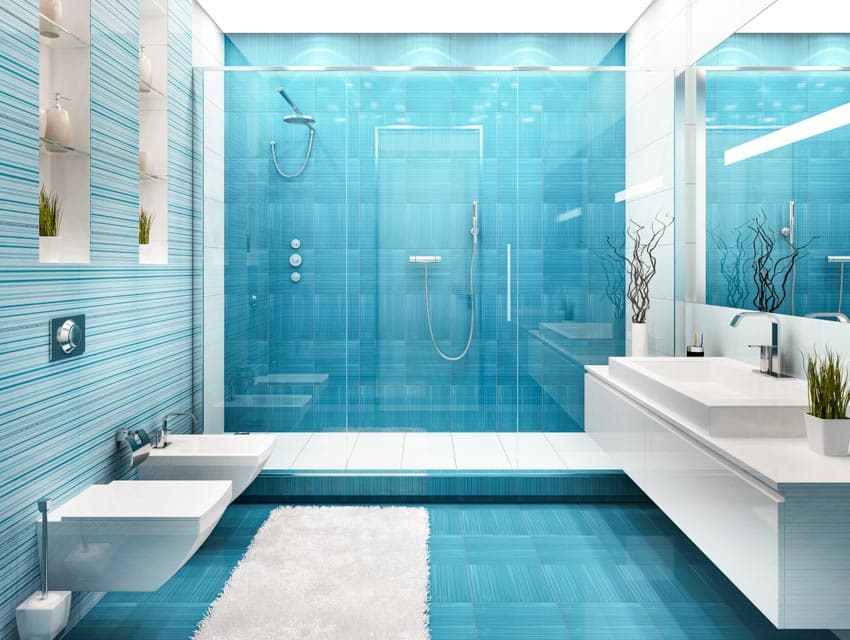 Bathroom with glass floor to ceiling tiles, glass door, toilet, bidet, floating vanity, countertop, sink, mirror, and windows