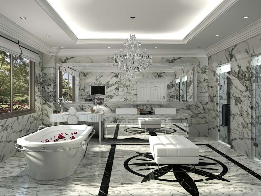 Bathroom with Impact Statuario marble wall, tub, ottoman, windows, and chandelier