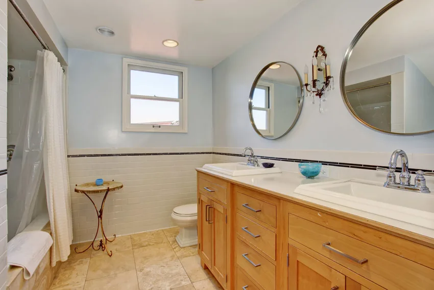 Bathroom with polyester curtain liner, mirror, cabinets, drawers, countertop, and faucet