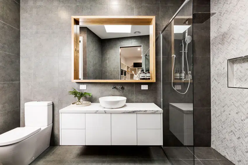 Bathroom with floating vanity, toilet, glass divider, and shower area