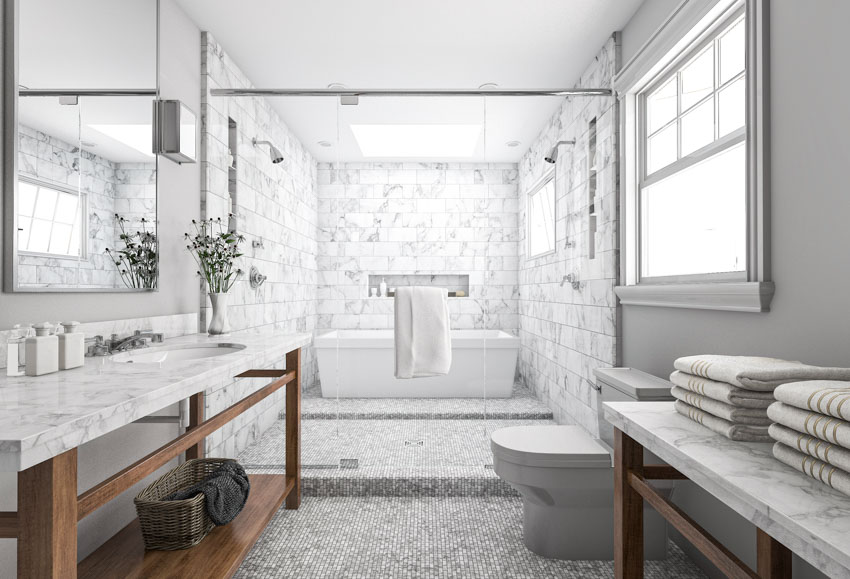Beautiful bathroom with quartz countertop, marble wall, tub, mirror, windows, and toilet