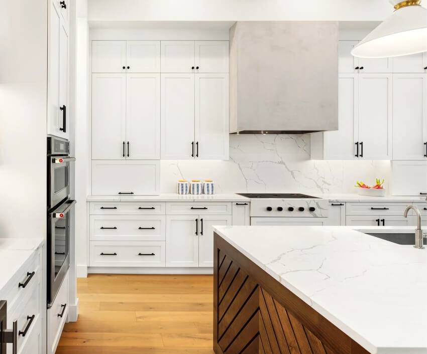 Kitchen with marble top counter, pendant lights and hardwood floors