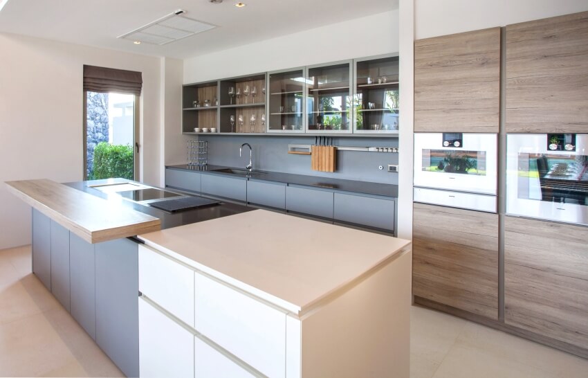 A beautiful modern kitchen interior with extended island and painted and thermofoil euro style kitchen cabinets