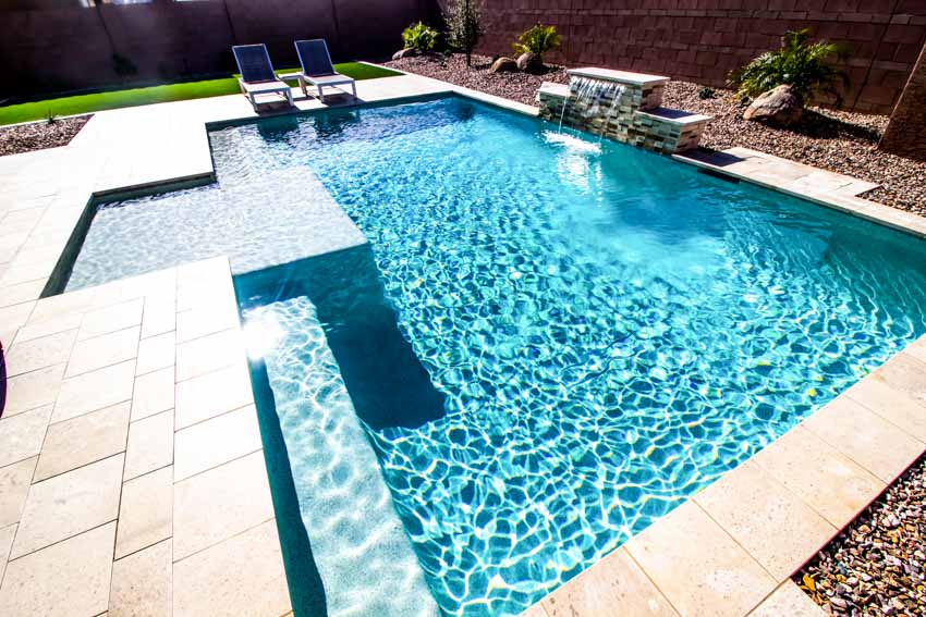 Beautiful swimming pool with tile deck, outdoor furniture, and pool plaster