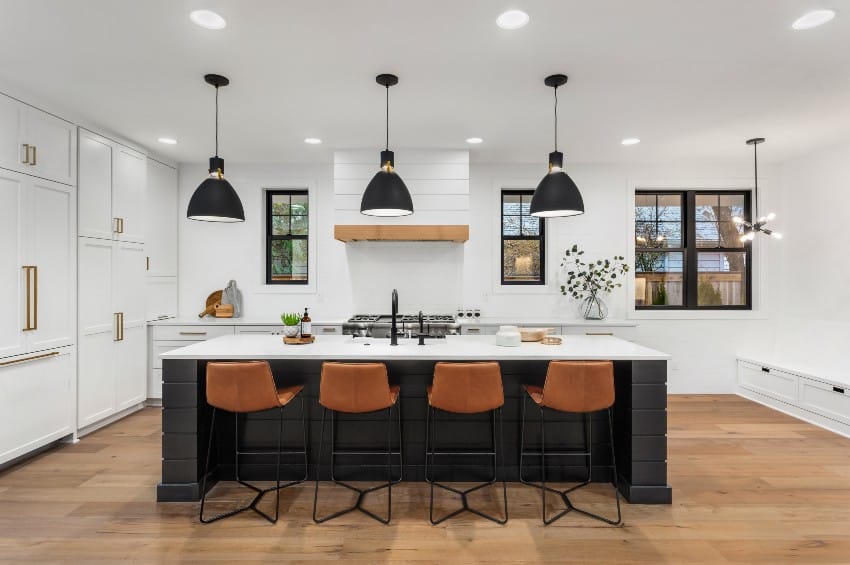Kitchen with dark accents, island counter and low back leather stool