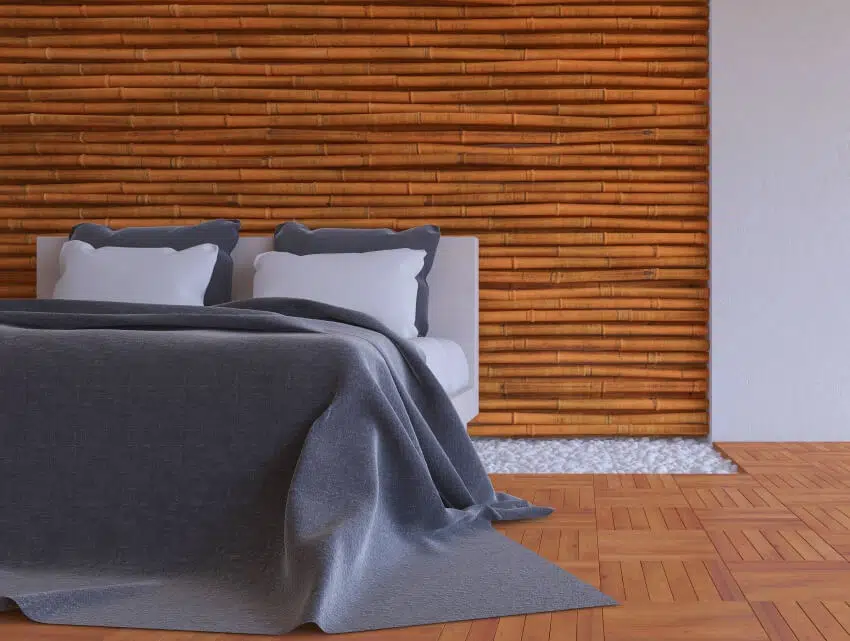 Bedroom with wooden floors bed and bamboo wall panel