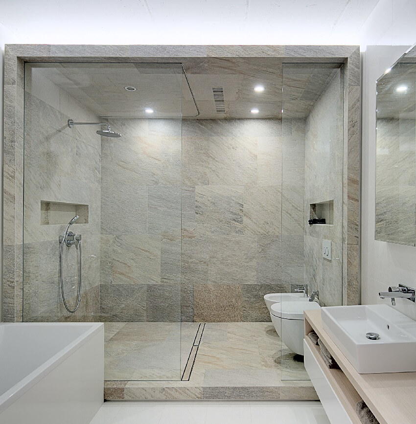 Bright bathroom with a box of tile walls, floor, and ceiling dedicated for shower and toilet