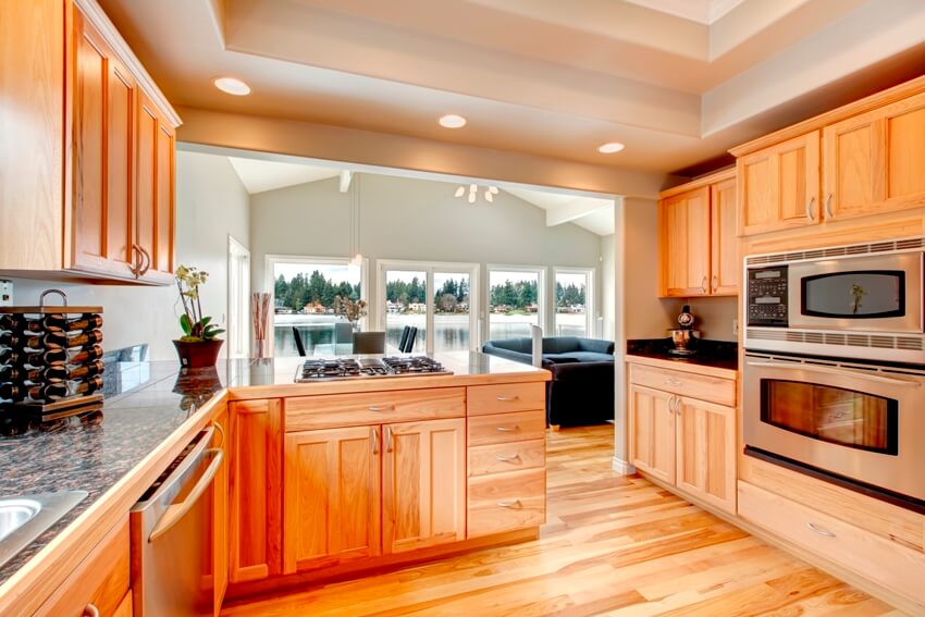 Kitchen with cabinets and bright dining space with a lake view